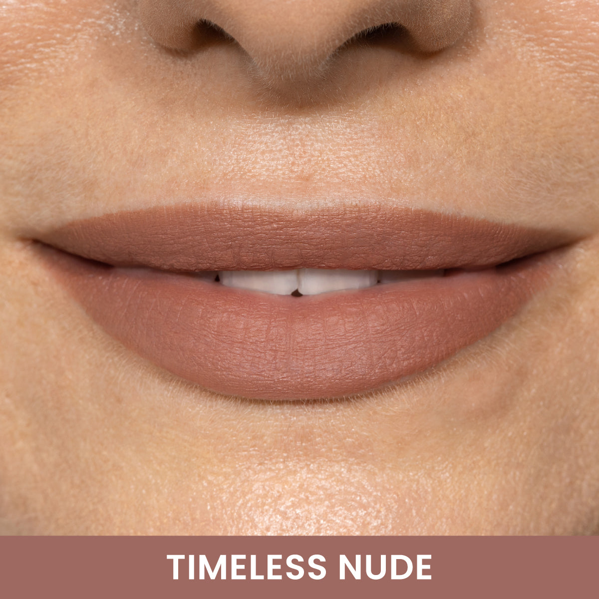 A close-up of smiling lips wearing matte nude lipstick, with the words TIMELESS NUDE written below on a matching background.