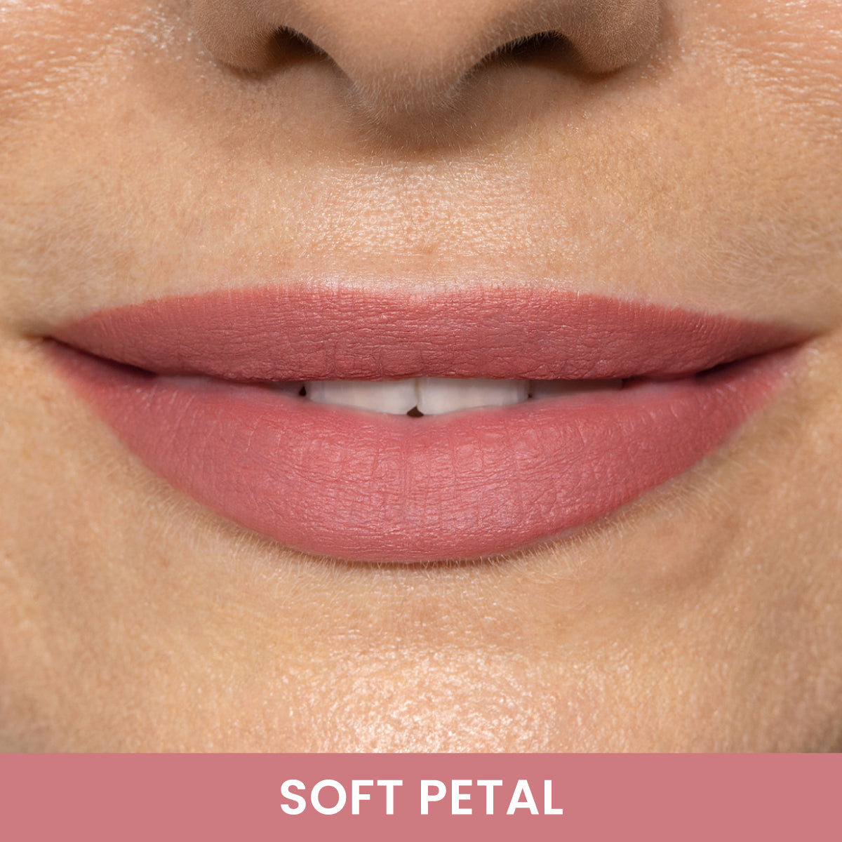 Close-up of a persons lips wearing soft pink lipstick. The lips are slightly parted, showing a hint of teeth. Text below the image reads SOFT PETAL on a matching pink background.
