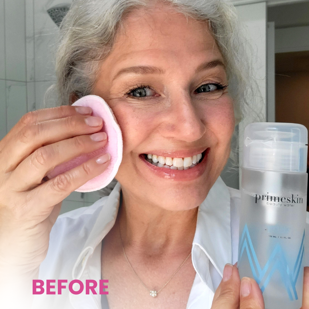 Smiling older woman with gray hair applies skincare with a cotton pad, holding a bottle labeled Primeskin in a bright bathroom. The word BEFORE is in bold pink letters in the lower left corner.