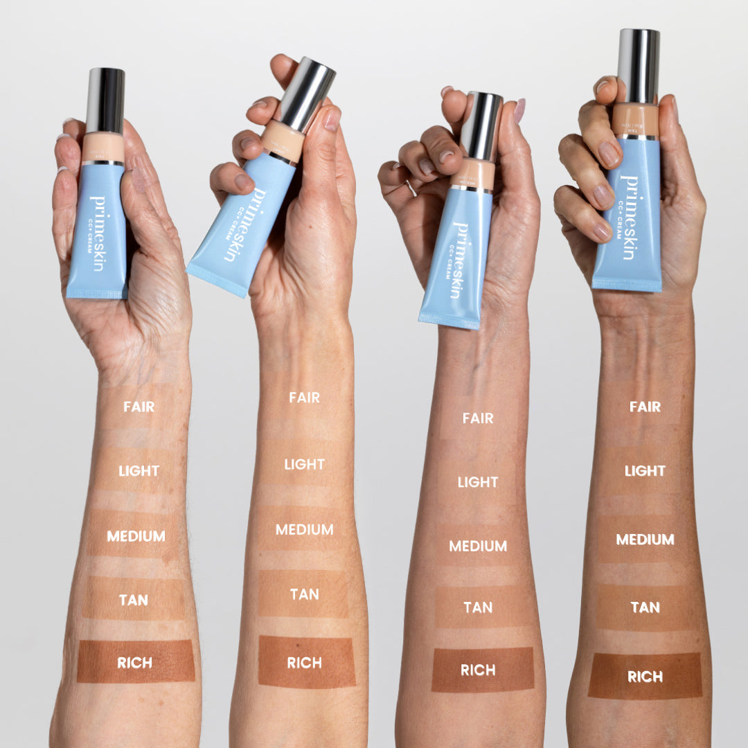 Three arms with different skin tones each display swatches labeled FAIR, LIGHT, MEDIUM, TAN, and RICH, holding blue tubes of Primaskin foundation in front of a light background.