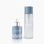 PrimePrometics™ PrimeSkin Magic Repair Serum + Beauty Water, featuring a blue dropper bottle and a tall clear bottle, are elegantly displayed on a white background.