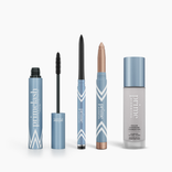 The Timeless Beauty Set by PrimePrometics™ features four blue and silver makeup products—mascara, eyeliner pencil, cream eyeshadow stick, and color changing foundation—standing upright against a white background.