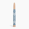 The PrimePrometics™ PrimeEyes Eye Brightener is a beige illuminating eyeshadow stick with a blue and gold tube, white chevron accents, and vertical branding—ideal for women over 50.