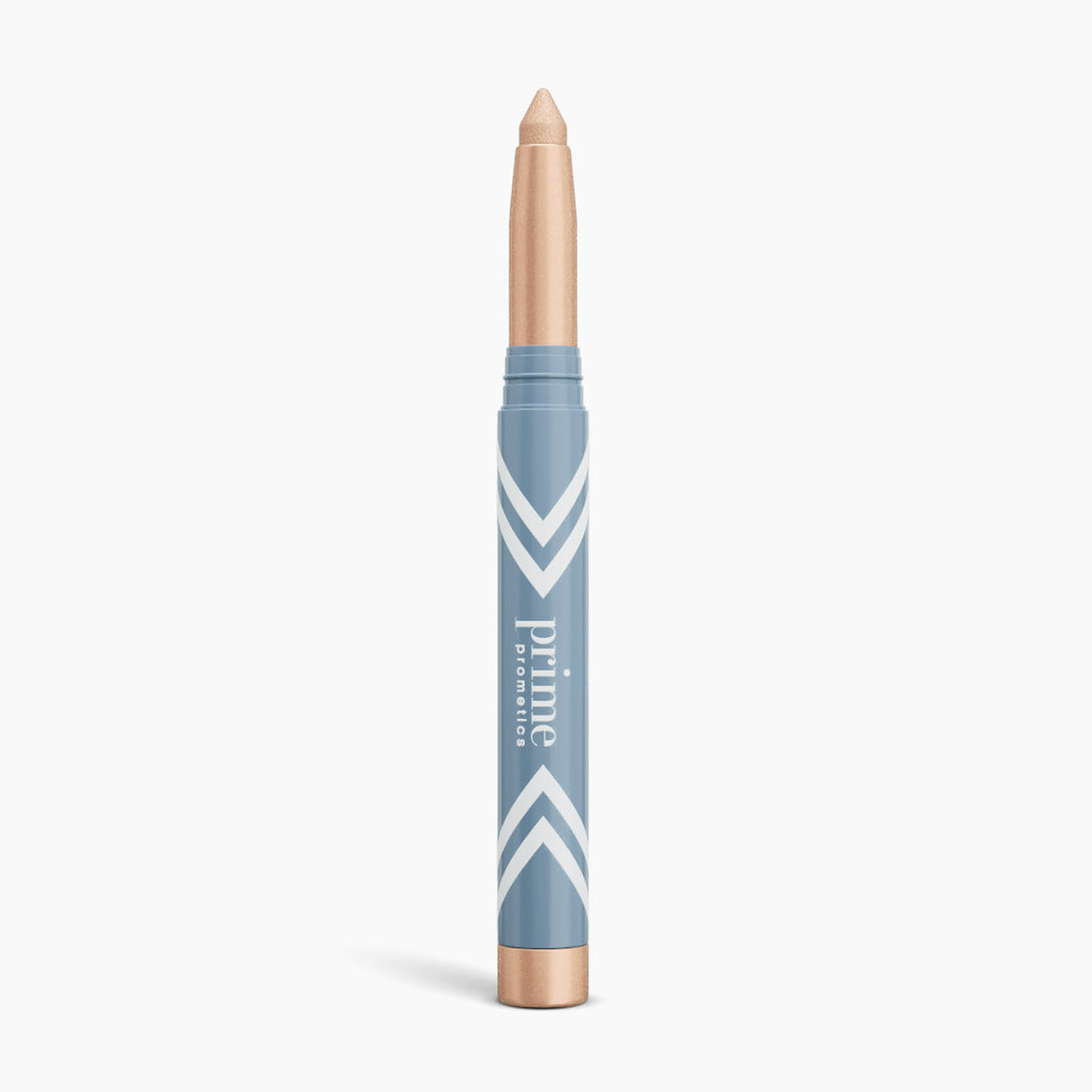 The PrimePrometics™ PrimeEyes Eye Brightener is a beige illuminating eyeshadow stick with a blue and gold tube, white chevron accents, and vertical branding—ideal for women over 50.