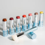 PrimeWand Brush displayed alongside the Prime Prometics PrimeWand color stick family in eight shades for cheeks and lips