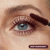 Closeup of an eye with Prime Prometics PrimeLash Mascara in Burgundy applied with the brush wand