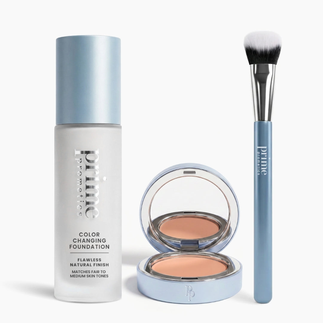 The PrimePrometics™ Face It, You're Flawless Set—featuring foundation, an open compact, and a concealer brush with white bristles and a blue handle—are arranged side by side on a white background.