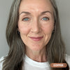 Mature gray-haired woman wearing Prime Prometics PrimeEyes Glide Eyeliner in Copper, a metallic copper shade