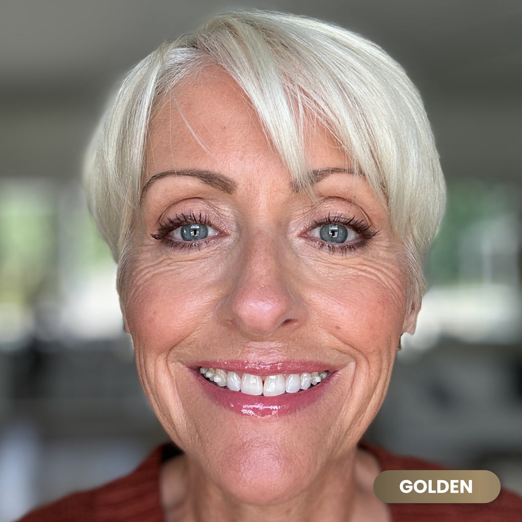 Mature woman with white hair wearing Prime Prometics PrimeEyes Glide Eyeliner in Golden, a metallic gold shade