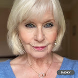 Mature white-haired woman wearing Prime Prometics PrimeEyes Glide Eyeliner in Smoky, a smoky charcoal shade
