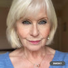 Mature white-haired woman wearing Prime Prometics PrimeEyes Glide Eyeliner in Smoky, a smoky charcoal shade