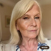 Mature blonde woman wearing Prime Prometics PrimeEyes Glide Eyeliner in Wood, a soft brown shade