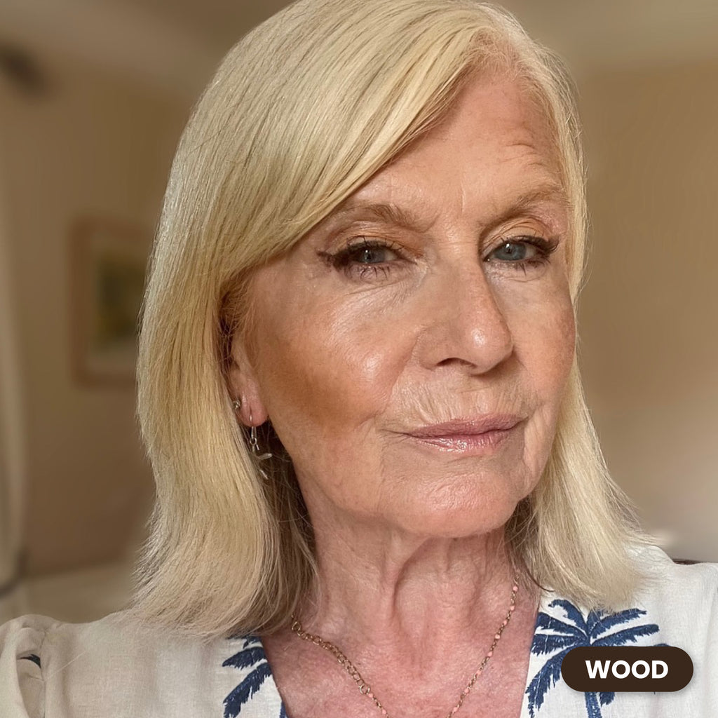 Mature blonde woman wearing Prime Prometics PrimeEyes Glide Eyeliner in Wood, a soft brown shade