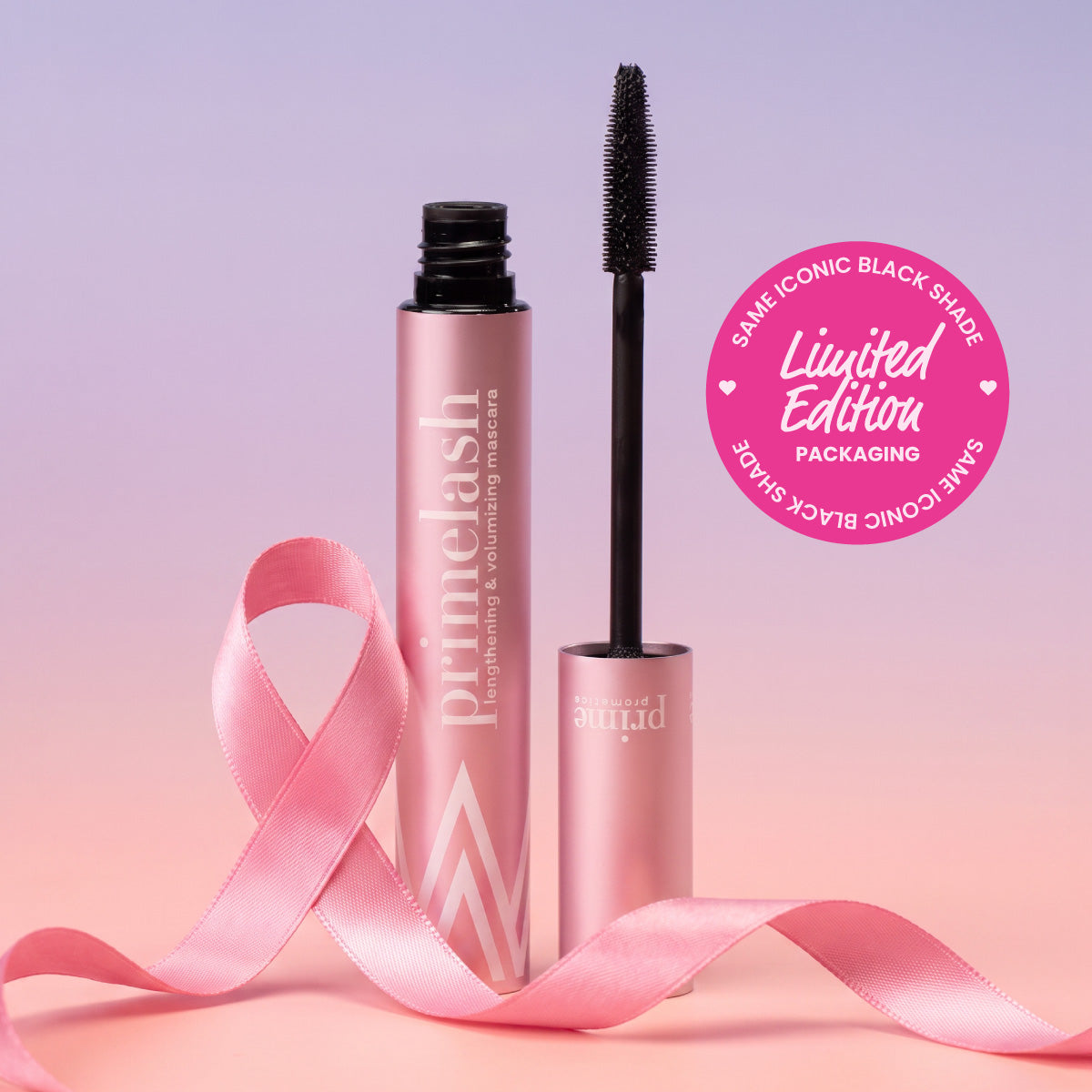 A pink tube of PrimeLash Mascara by PrimePrometics™ with the wand exposed, beside a pink ribbon. A pink circle reads Limited Edition Packaging—Same Iconic Black Shade. The background is a soft pink-purple gradient.
