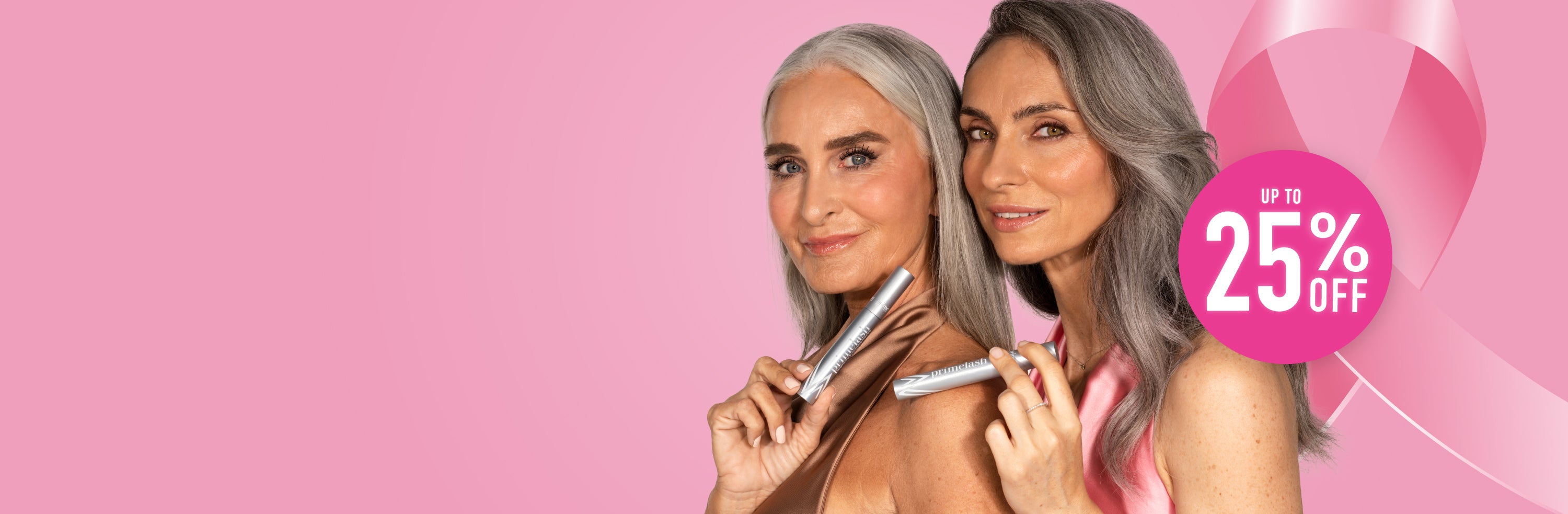 Two women with long gray hair hold beauty products against a pink background with a large pink ribbon and a circle that says Up to 25% OFF, suggesting a breast cancer awareness promotion.