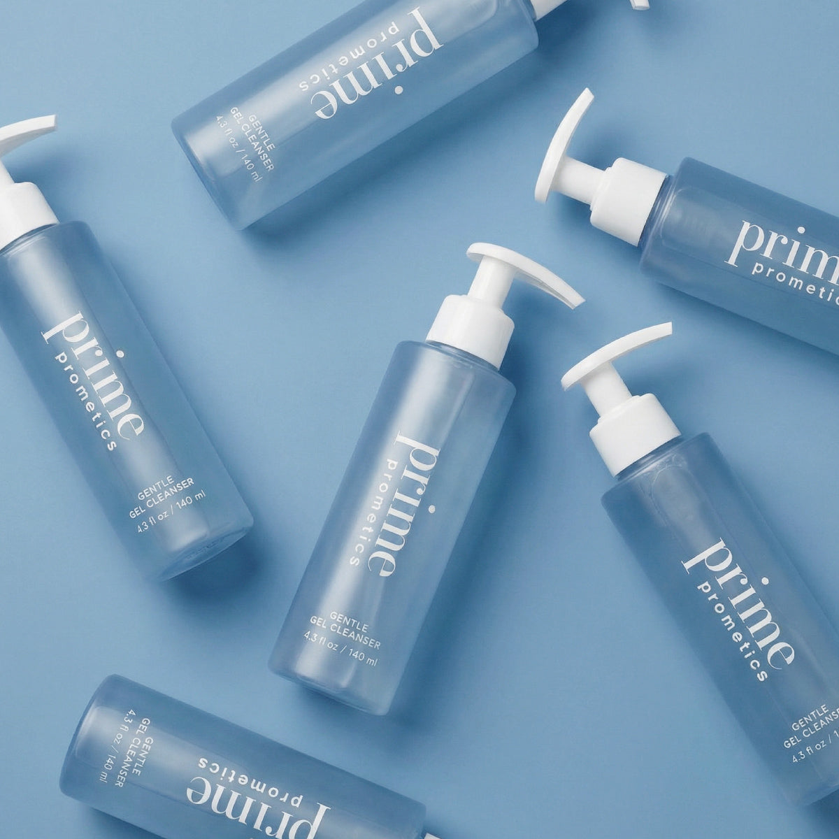 Several blue bottles of Prime Prometics Gentle Gel Cleanser with white pump dispensers are arranged diagonally on a light blue background.