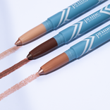 Three PrimePrometics™ Build Your Own Bundle makeup pencils in blue casings draw light beige, deep brown, and pinkish nude lines on a white surface—ideal for pro-age beauty and complementing your skincare routine.