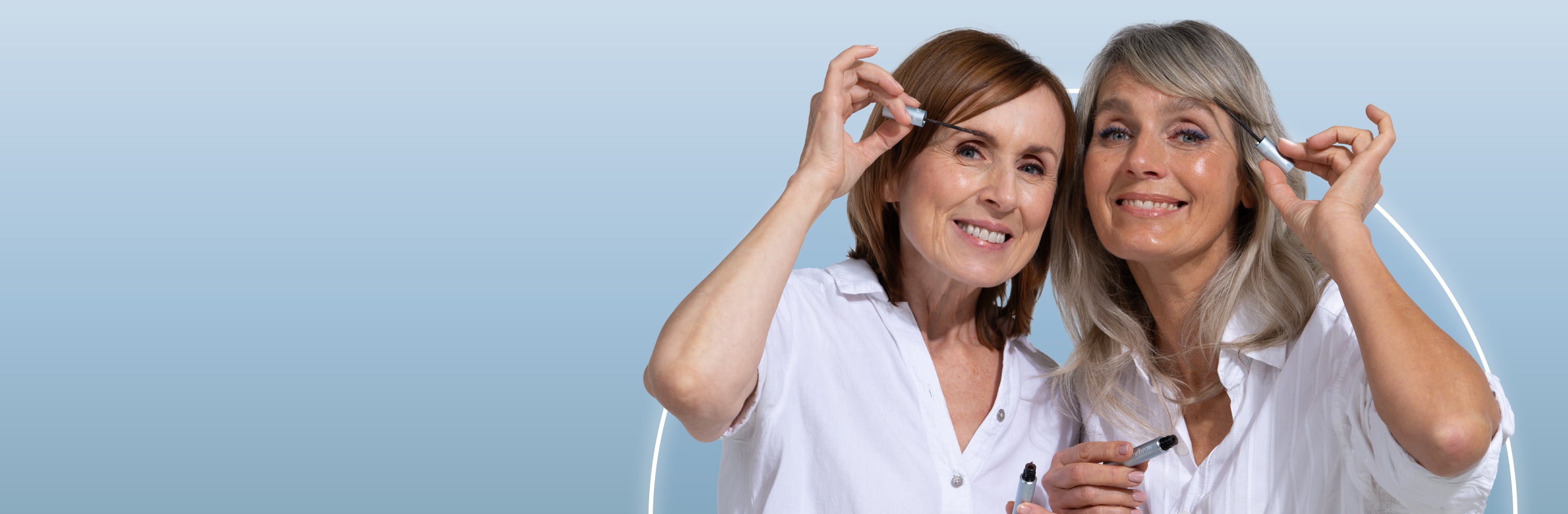 Two smiling women with light hair apply skincare serum to their faces. Both wear white shirts and stand against a light blue gradient background.