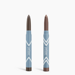 Two blue Complete Eye Sticks Kit by PrimePrometics™ stand upright on a white background, each with brown-tipped ends and chevron designs—ideal for use as matte eyeshadow or eye brightener.