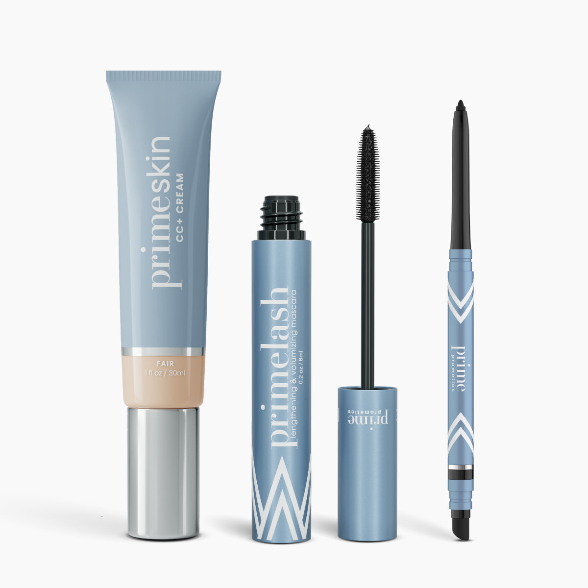 Four blue PrimePrometics™ products from the Essential Face & Eyes Bundle stand upright, featuring light blue and white geometric designs: primeskin CC+ Cream, open Mascara primelash, Eyeliner pencil, and a dual-ended makeup stick.