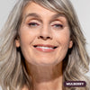 Mature woman with gray hair wearing Prime Prometics PrimeEyes Glide Eyeliner in Mulberry, a deep berry shade