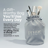 A gift-worthy Prime Velvet Bag for gifting, travel, or storing everyday essentials, shown filled with mascara, foundation, and a brush