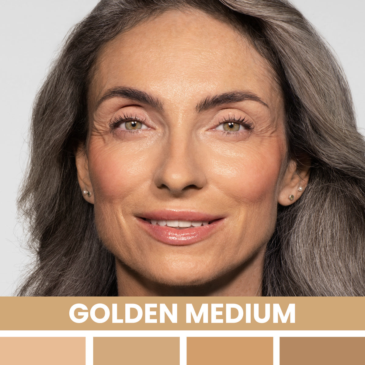 A smiling woman with wavy gray hair and natural makeup is shown. Below her face, the words GOLDEN MEDIUM appear above four swatches of medium golden foundation shades.