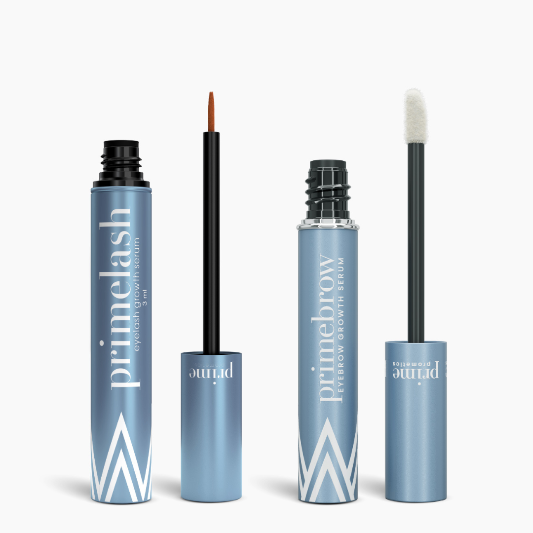 PrimePrometics™ PrimeLash Growth Serum + PrimeBrow Growth Serum come in two metallic blue tubes with white text: one with a thin brush for lashes, the other with a thicker sponge-tip for brows.