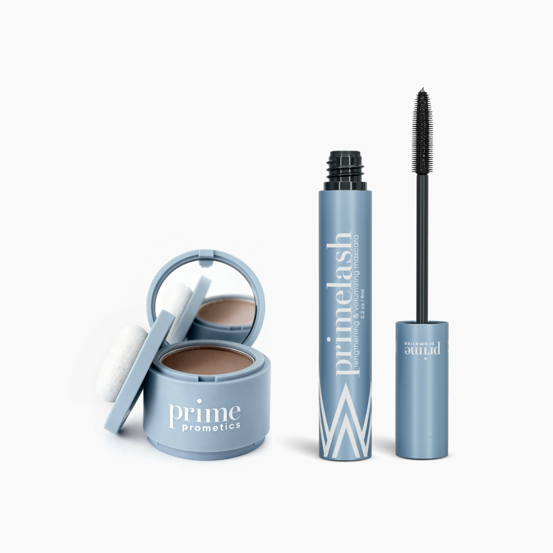 Two blue PrimePrometics™ Beauty Essentials Set products: an open compact with Hairline Powder and puff on the left, and an open tube of PrimeLash Mascara with the wand out on the right, both displayed on a white background.