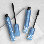 Prime Prometics PrimeLash Mascara and PrimeLash Volumizer tubes with brush wands lying together on a textured fabric