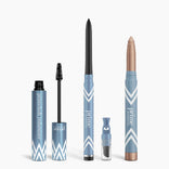 Four blue PrimePrometics™ Line & Lift Bundle products stand upright: Volumizer mascara with brush wand, PrimeEyes Glide twist-up eyeliner, shimmery eyeshadow stick, and clear-tipped applicator—all feature white geometric patterns.
