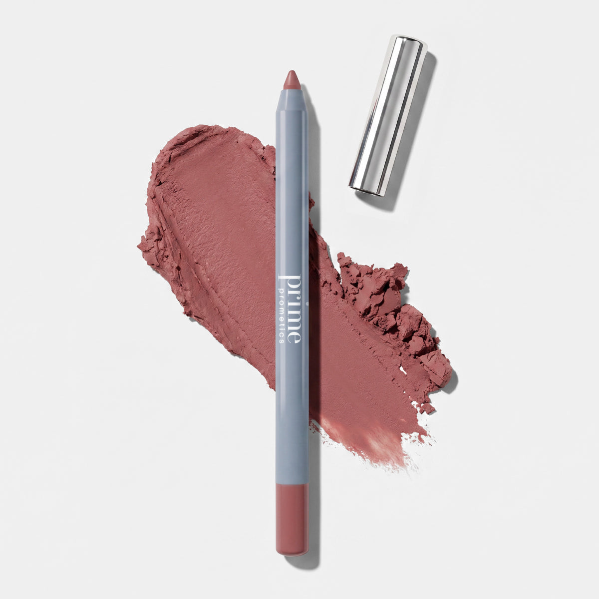 PrimePrometics™ Velvet Lip Contour, a mauve lip liner with a silver cap, lies on a matching mauve smudge against a white background. Designed for mature lips, it offers precision and comfort for an effortlessly defined look.