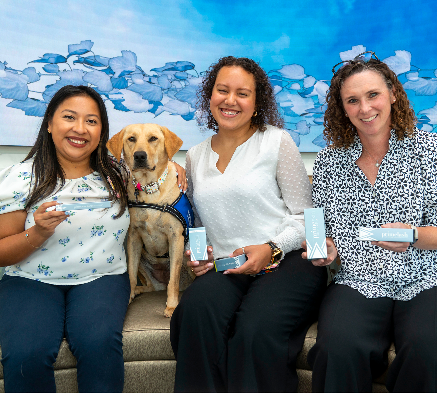 Three Prime Prometics community members with a yellow Labrador.
