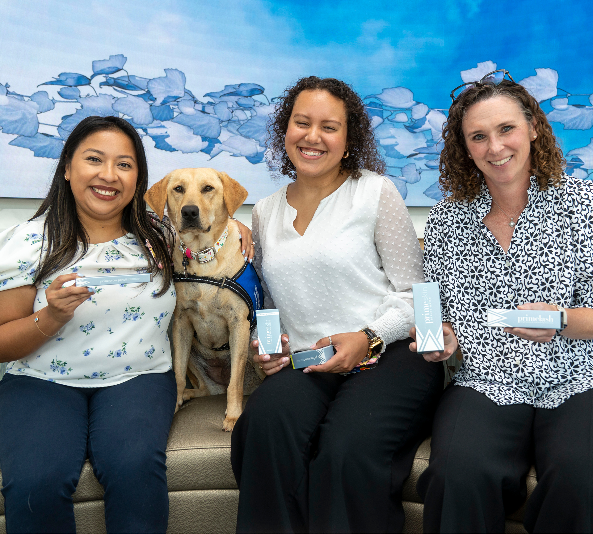 Three Prime Prometics community members with a yellow Labrador.