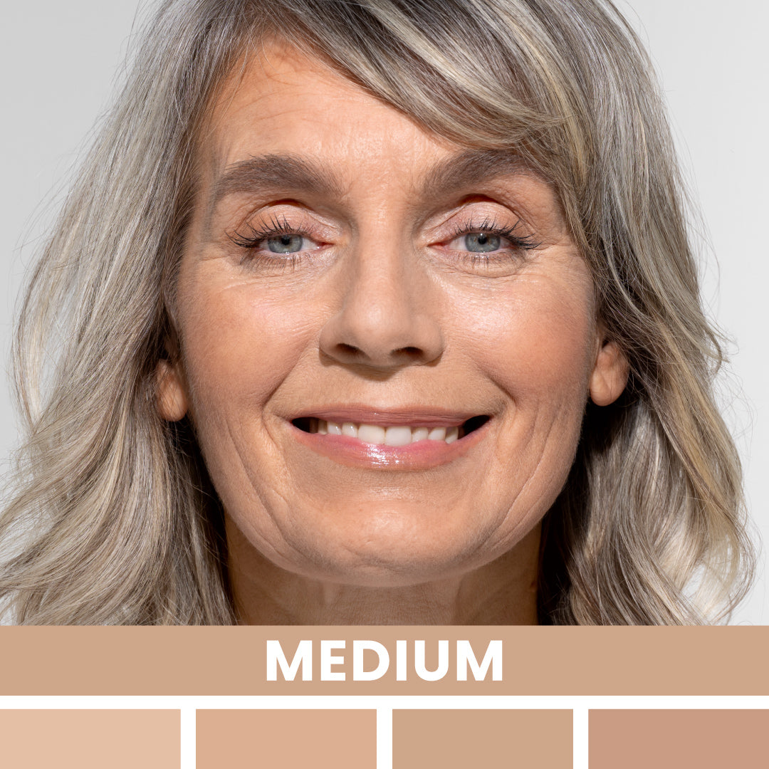 A smiling older woman with light gray hair and medium skin tone, shown against a neutral background. The word MEDIUM appears below her face, above several swatches of medium skin tone shades.