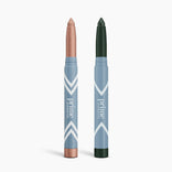 Two PrimePrometics™ PrimeEyes Eye Brightener sticks stand upright, one shimmery rose gold and one deep green. Both feature blue barrels with white chevrons—perfect for brightening and illuminating your eye area. Set includes 2 pieces.