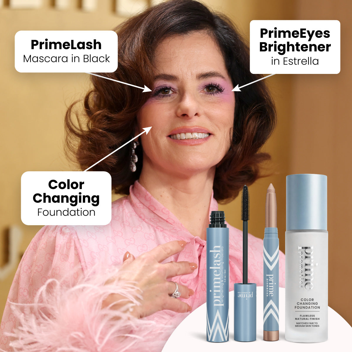 A woman with wavy brown hair wears pink eye makeup and a light pink blouse. Labeled arrows highlight her mascara, eyeshadow stick, and foundation. The makeup products are shown in front of her.