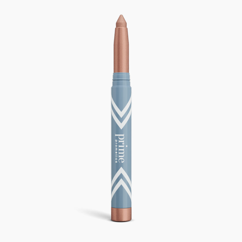 A metallic rose gold makeup crayon with a blue and white patterned tube labeled Prime Prometics, standing upright on a white background.