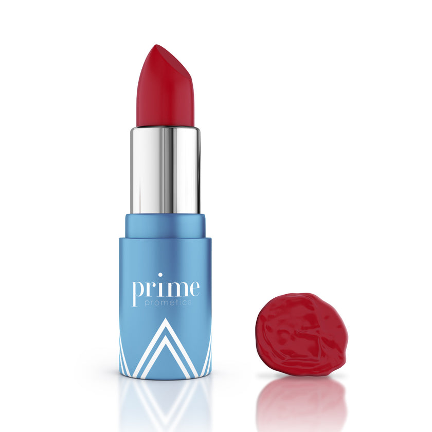 A red lipstick in a shiny silver and blue tube labeled prime, standing upright next to a smudged sample of the same red lipstick, both on a white background.