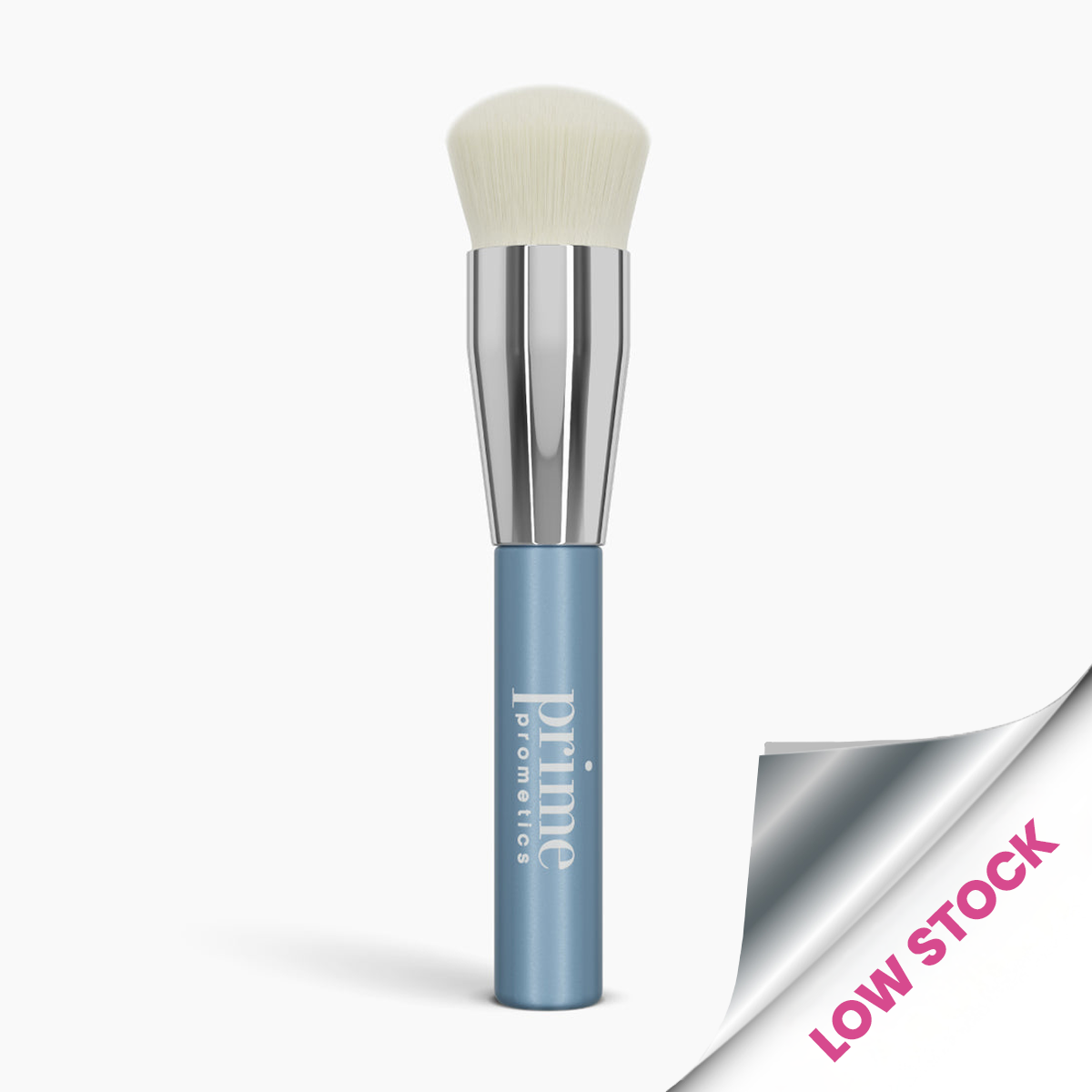 A makeup brush with a blue handle labeled priime pomettes and soft white bristles. The bottom right corner has a silver sticker with pink text that reads LOW STOCK.