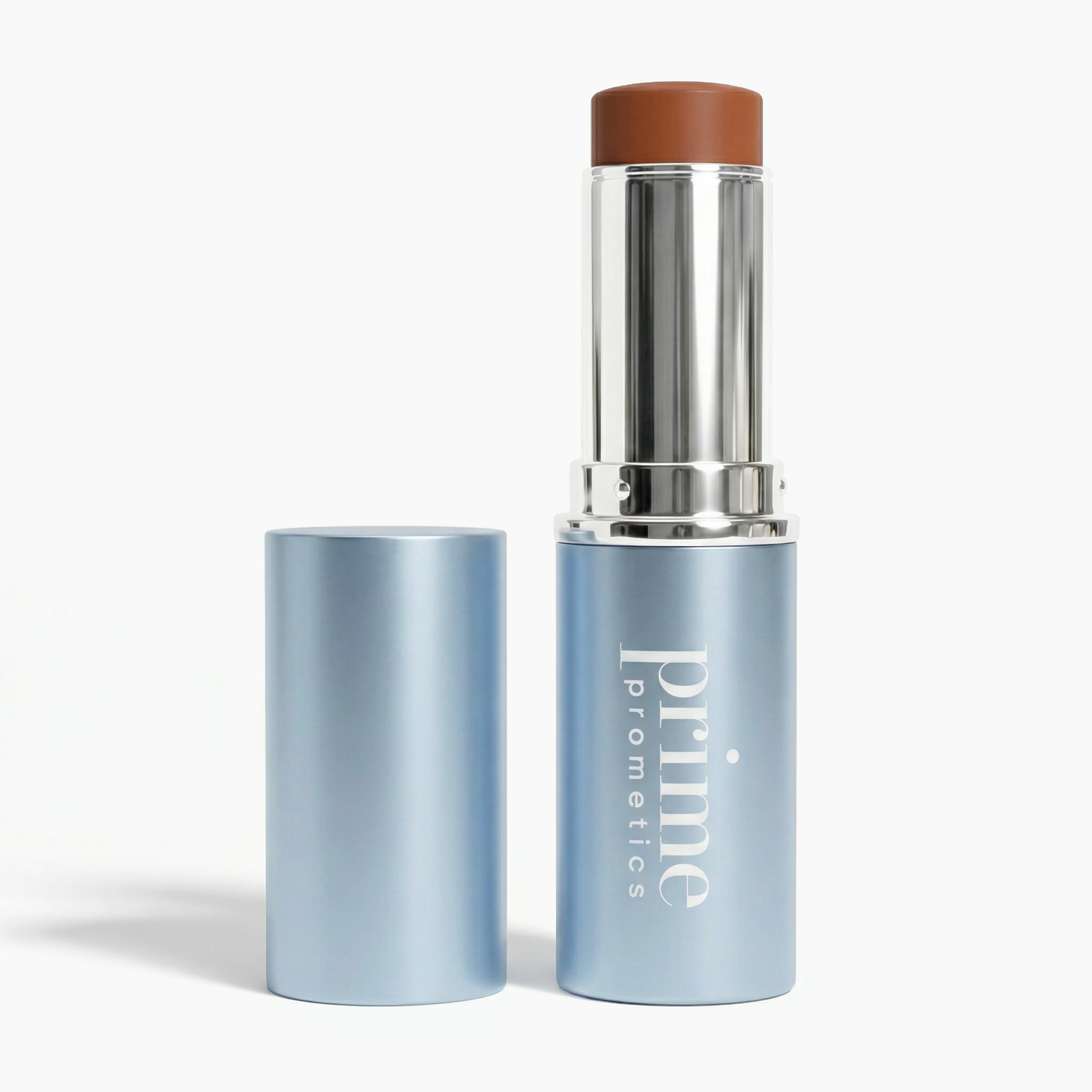 A blue tube of PrimePrometics™ PrimeWands 5-in-1 Makeup Wand, with the cap off to reveal the brown product inside, stands on a white background. This versatile multi-use wand offers buildable color for a flawless, radiant finish.