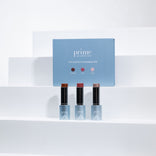 A blue PrimePrometics™ PrimeWand Contour Kit box sits behind three contour sticks labeled "Prime," each offering bronzer, highlighter, and contour in one, all displayed on white tiered steps against a minimalist bright background.
