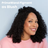 PrimeWand Pigment as Blush: a mature woman with dark curly hair wearing Prime Prometics PrimeWand Pigment as a flush of color on her cheeks