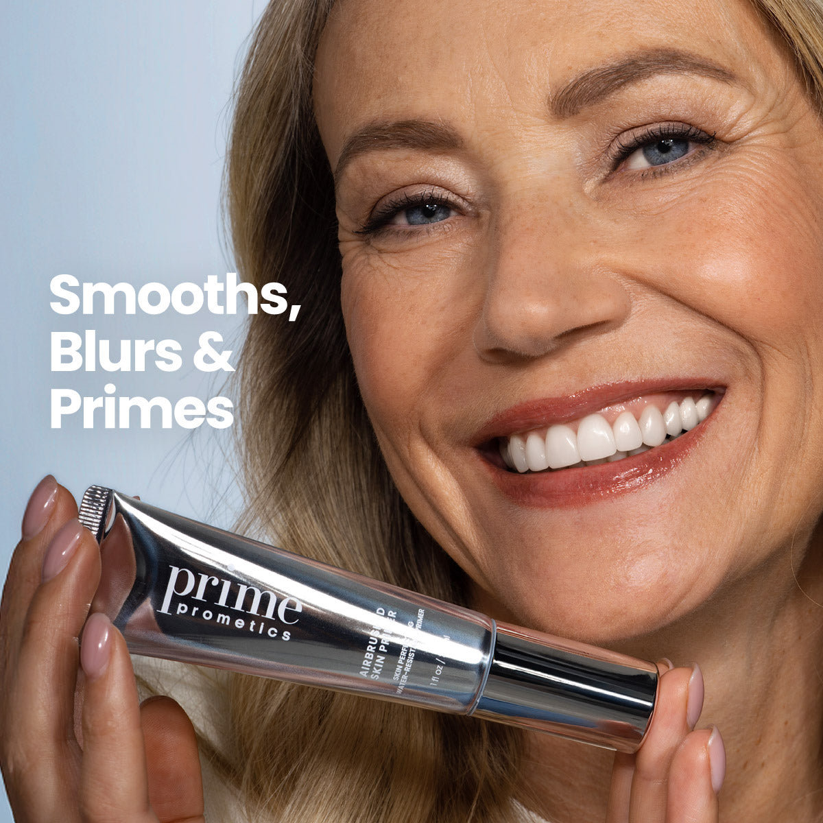 Mature blonde woman smiling and holding the Prime Prometics Airbrushed Skin Primer tube near her face, with the caption smooths, blurs, and primes