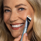 Mature woman gliding the Spatula Brush across her cheek for a smooth, airbrushed full-coverage finish