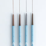 Four PrimePrometics™ Build Your Own Bundle eyebrow pencils with blue bodies stand vertically on a white surface, each drawing a line in a different shade—ideal for pro-age beauty and pairing with your skincare routine.