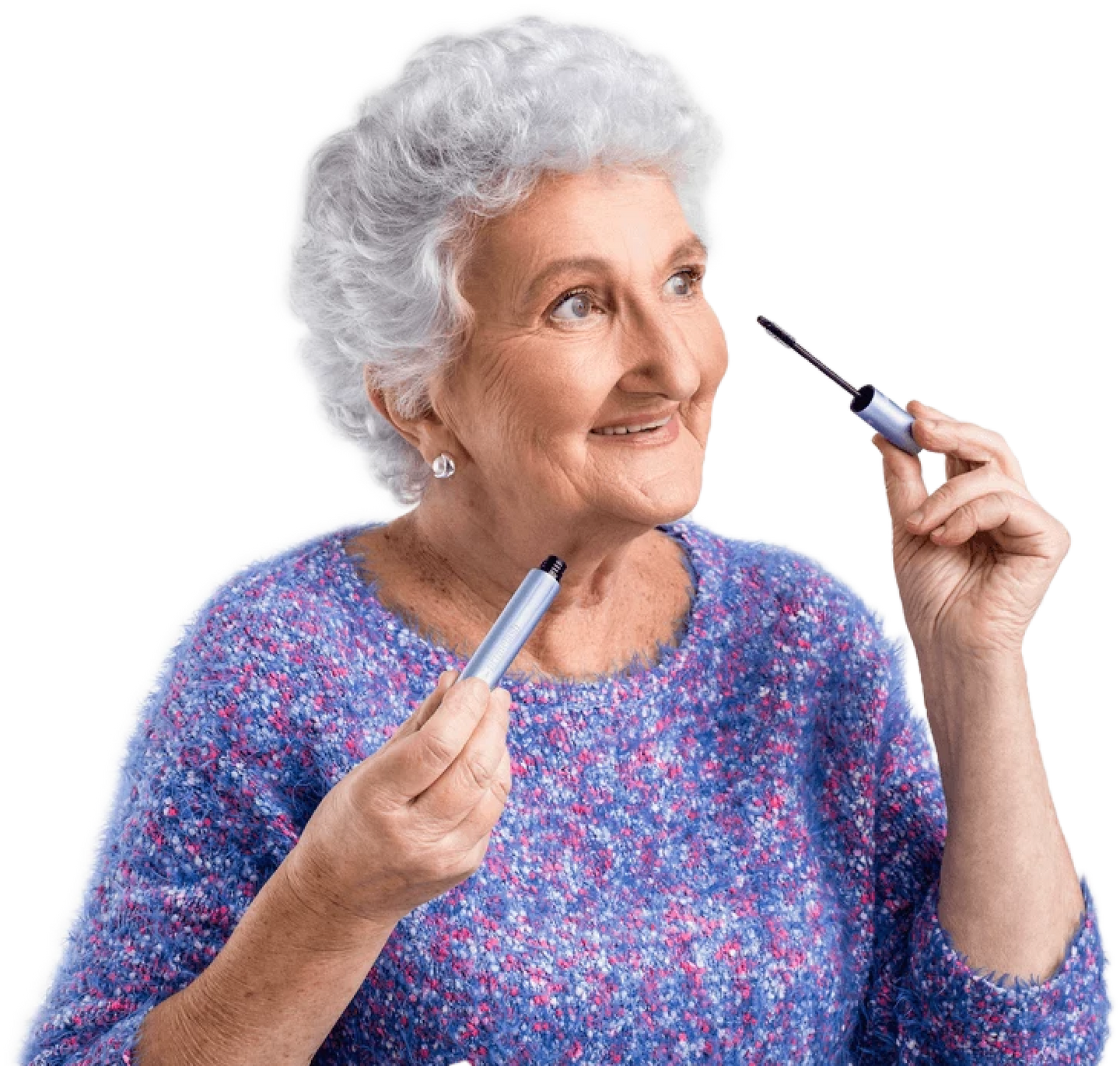 Elderly woman with short curly gray hair and a blue sweater smiling while holding a mascara wand near her eye, as if about to apply makeup.