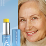 Mature woman smiling beside the Prime Prometics PrimeWand Nourish moisturizer stick