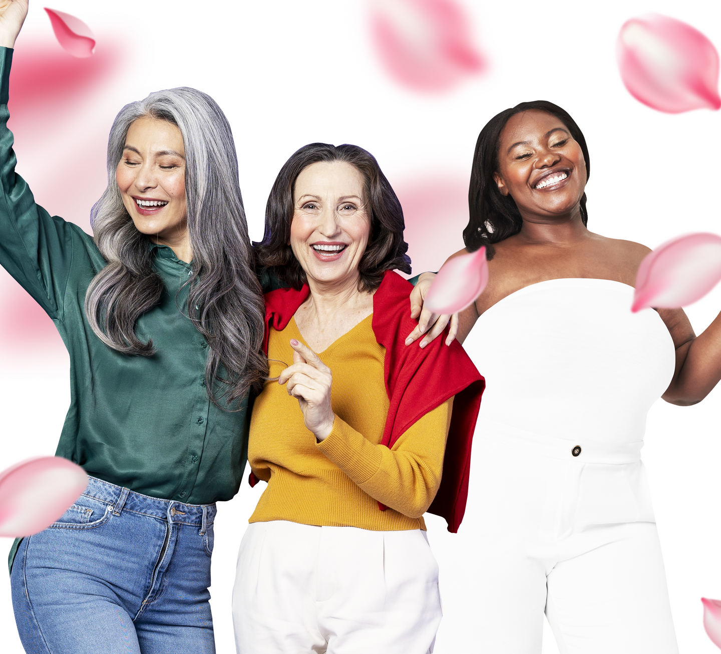 Three women of different ages and ethnicities smiling and posing together among falling pink rose petals